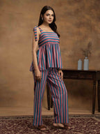 Woman wearing a striped cotton outfit standing perfect for a beach vacation, traveling, or daily wear.