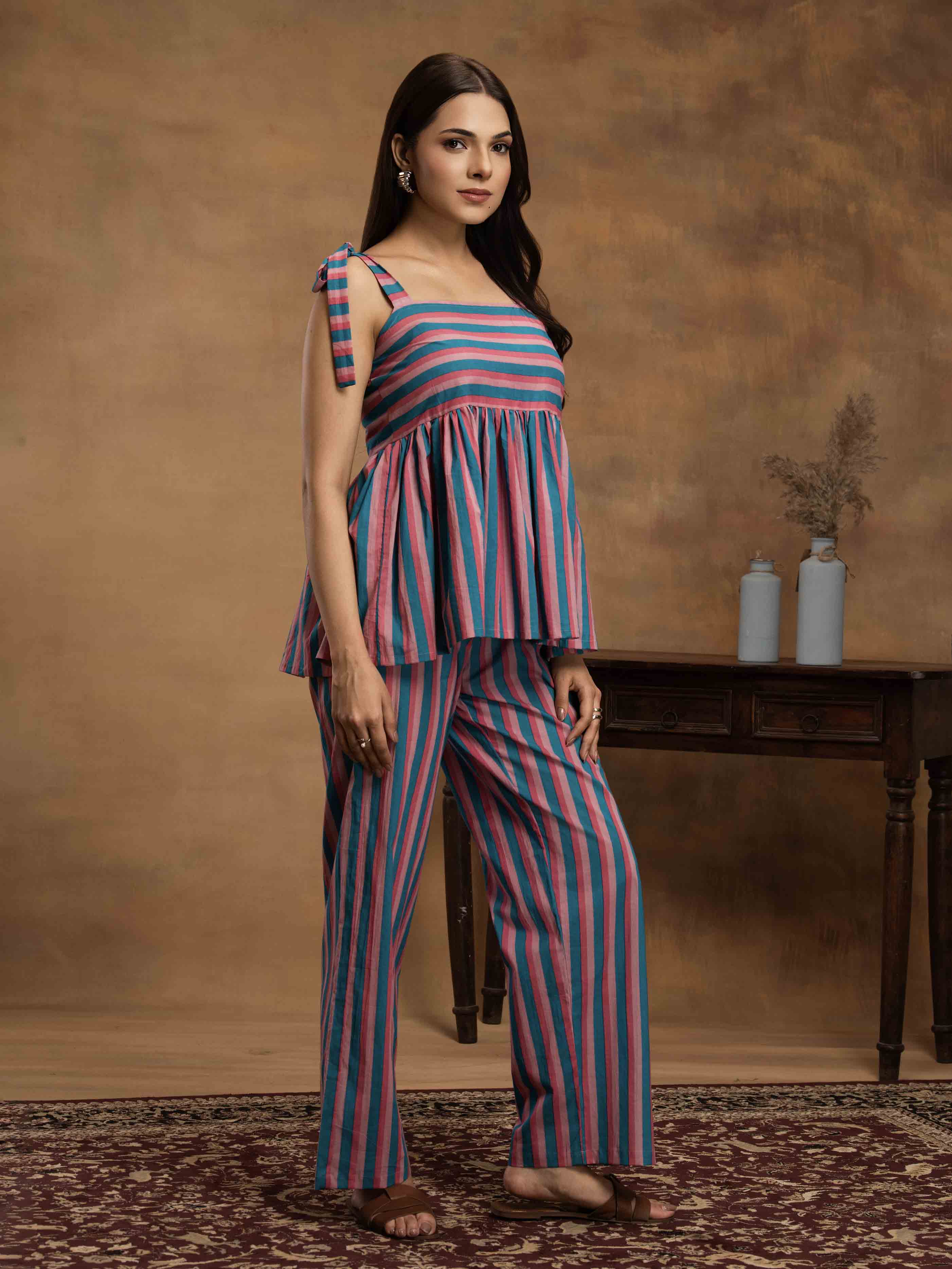 Woman wearing a striped cotton outfit standing perfect for a beach vacation, traveling, or daily wear.