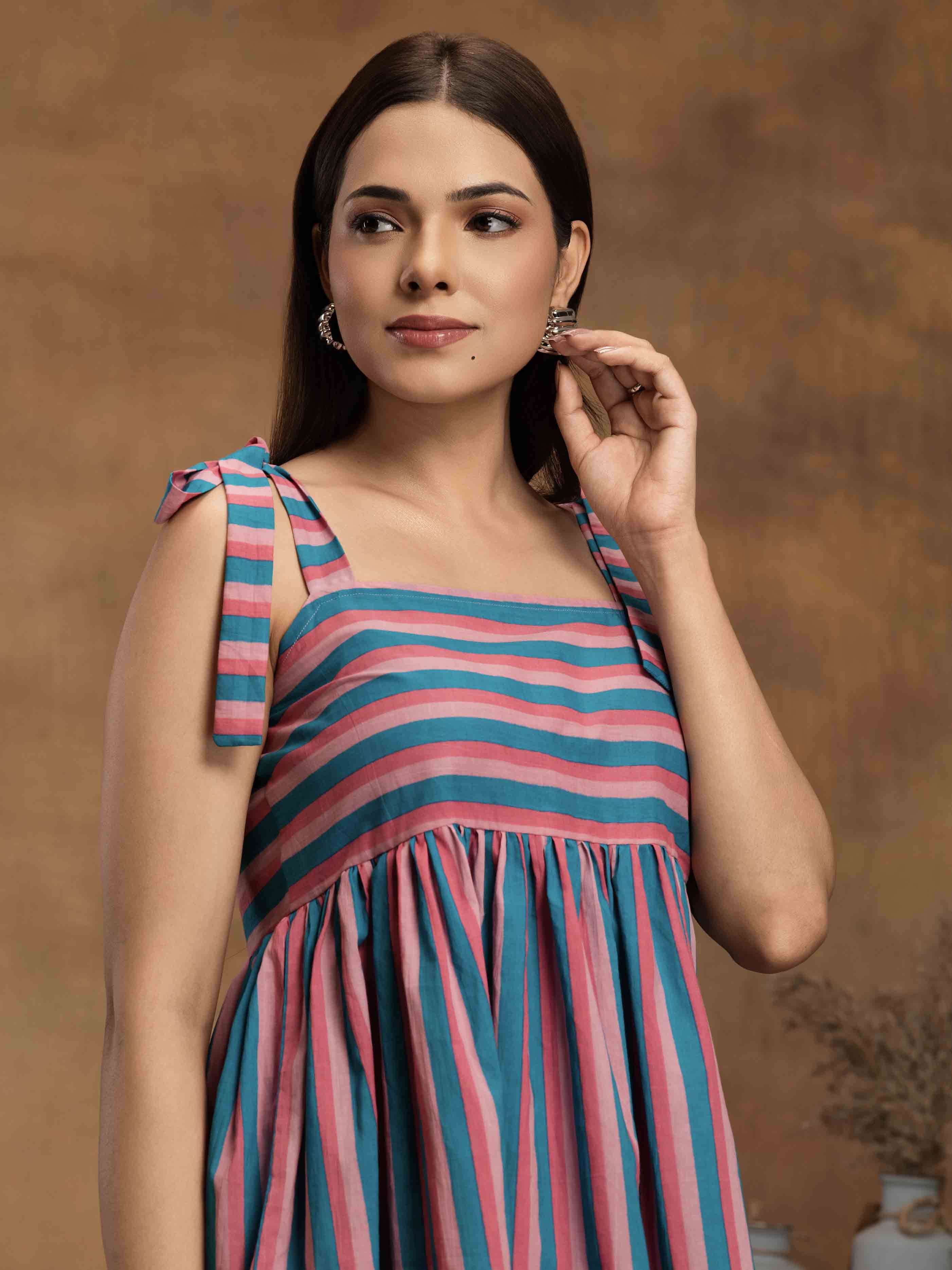 Woman wearing a striped cotton outfit standing perfect for a beach vacation, traveling, or daily wear.