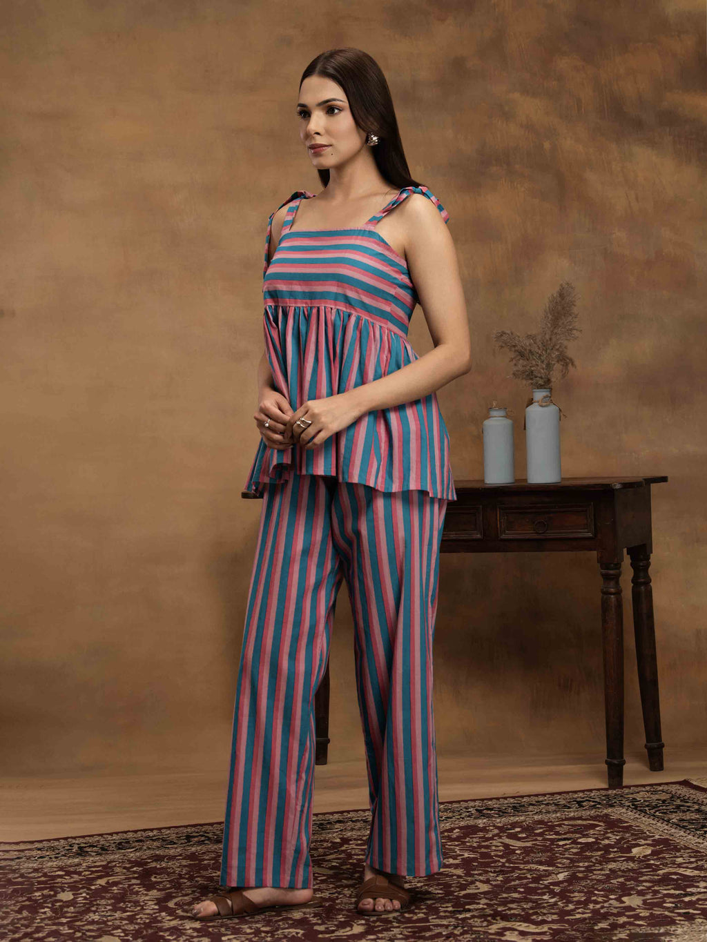 Woman wearing a striped cotton outfit standing perfect for a beach vacation, traveling, or daily wear.