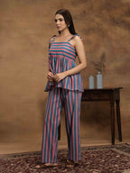 Woman wearing a striped cotton outfit standing perfect for a beach vacation, traveling, or daily wear.