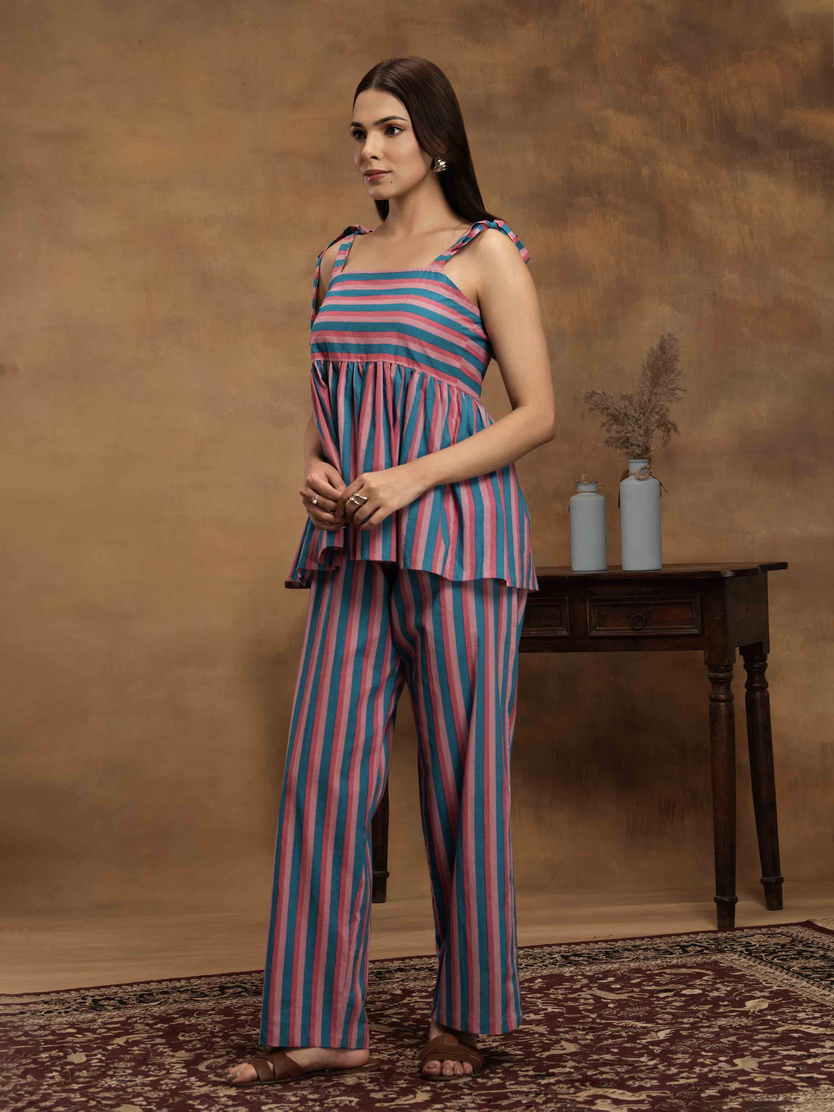 Woman wearing a striped cotton outfit standing perfect for a beach vacation, traveling, or daily wear.